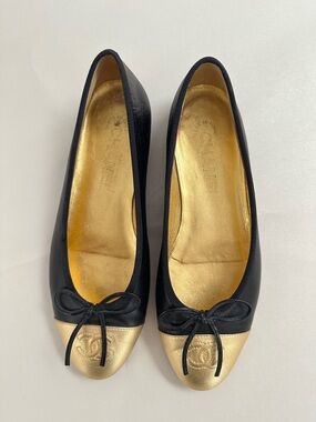 CHANEL Black and Gold Cap-Toe Bow Ballet Flats